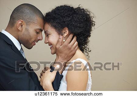 Stock Photography - Bride and groom embracing. Fotosearch