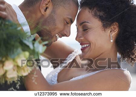Stock Photography - Bride and groom embracing. Fotosearch