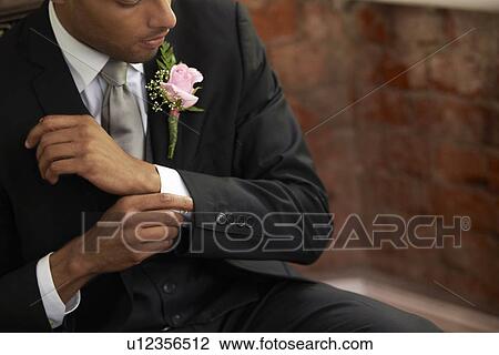 Stock Image - Bridegroom adjusting cuff. Fotosearch