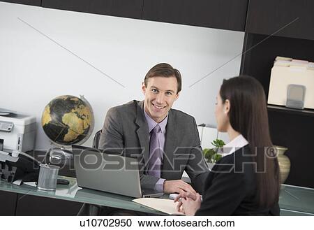 Businessman talking to businesswoman View Large Photo Image Stock Image - Businessman talking to businesswoman. Fotosearch