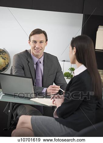 Businessman talking to businesswoman View Large Photo Image Stock Photo - Businessman talking to businesswoman. Fotosearch