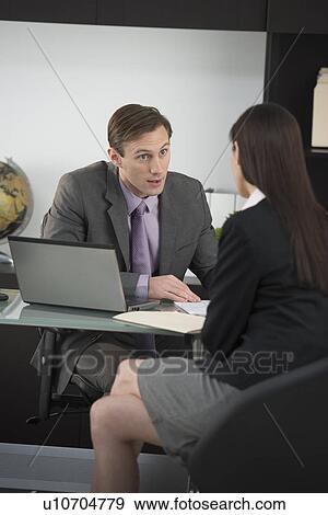 Businessman talking to businesswoman View Large Photo Image Stock Photo - Businessman talking to businesswoman. Fotosearch