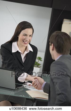 Businesswoman and businessman shaking hands View Large Photo Image Stock Photograph - Businesswoman and businessman shaking hands. Fotosearch