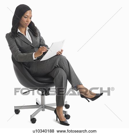 Businesswoman sitting in chair View Large Photo Image Stock Photo - Businesswoman sitting in chair. Fotosearch
