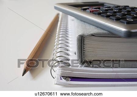 Calculator, textbook and pencil on notebook, studio shot View Large Photo Image Stock Image - Calculator, textbook and pencil on notebook, studio shot. Fotosearch