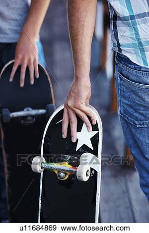 Close-up of men holding skateboardes View Large Photo Image Stock Photo - Close-up of men holding skateboardes. Fotosearch