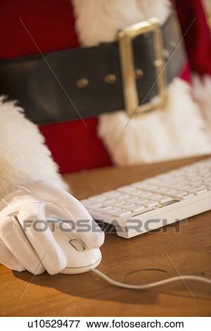 Close-up of santa claus using computer View Large Photo Image Stock Photo - Close-up of santa claus using computer. Fotosearch