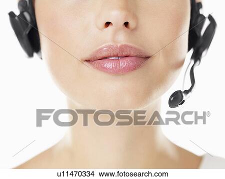 Picture - Close-up of woman wearing headset. Fotosearch