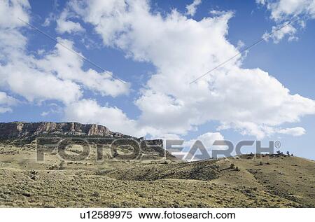 Clouds over barren landscape View Large Photo Image Stock Photography - Clouds over barren landscape. Fotosearch