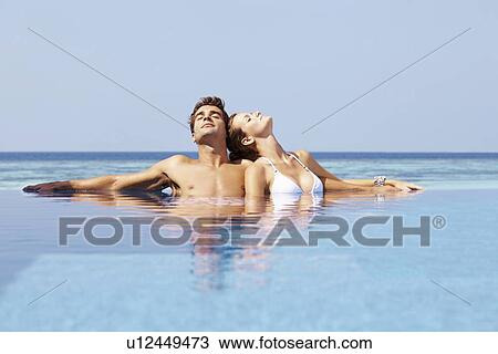 Couple at swimming pool View Large Photo Image Stock Image - Couple at swimming pool. Fotosearch