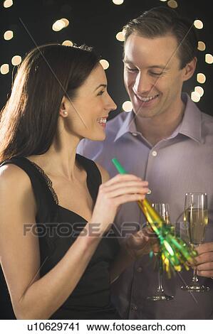 Stock Image - Couple celebrating new year's eve. Fotosearch