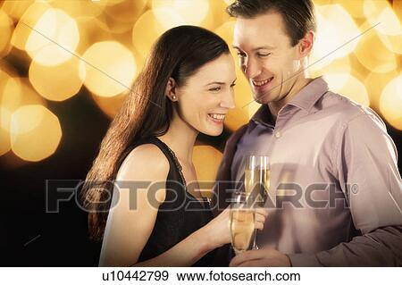 Stock Photo - Couple celebrating new year's eve. Fotosearch