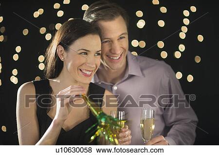 Couple celebrating new year's eve View Large Photo Image Stock Photo - Couple celebrating new year's eve. Fotosearch