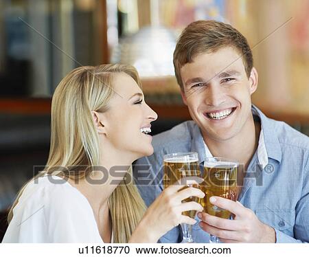 Stock Image - Couple drinking beer. Fotosearch