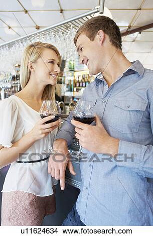 Couple drinking wine in bar View Large Photo Image Picture - Couple drinking wine in bar. Fotosearch