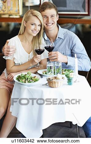 Stock Image - Couple drinking wine in restaurant. Fotosearch