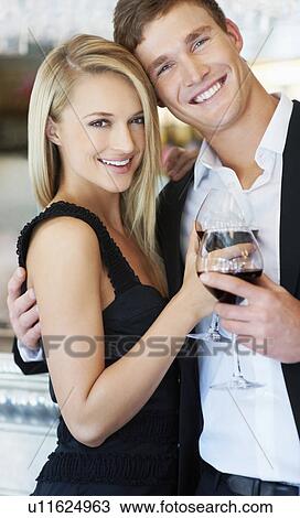 Stock Image - Couple drinking wine in restaurant. Fotosearch