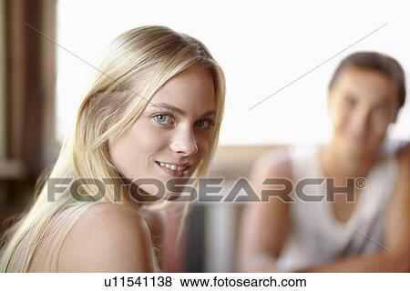 Stock Photo - Couple, focus on woman. Fotosearch