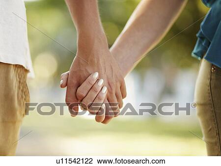 Stock Image - Couple holding hands. Fotosearch