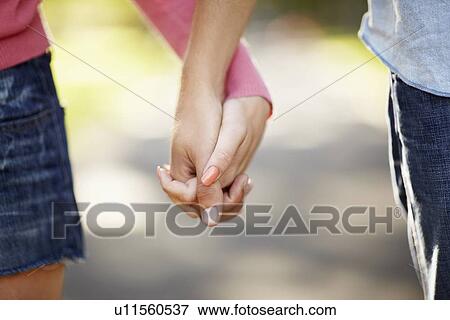 Stock Photo - Couple holding hands. Fotosearch