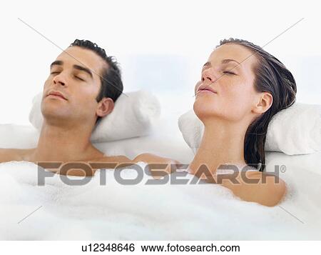 Couple relaxing in bathtub View Large Photo Image Stock Photograph - Couple relaxing in bathtub. Fotosearch
