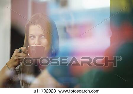 Stock Image - Couple relaxing in coffee shop. Fotosearch