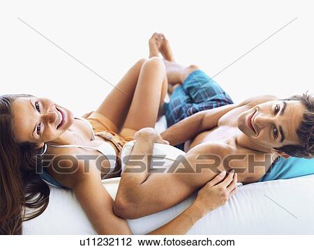 Couple relaxing on sofa together View Large Photo Image Stock Image - Couple relaxing on sofa together. Fotosearch
