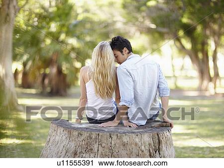 Couple sitting on tree stump View Large Photo Image Stock Image - Couple sitting on tree stump. Fotosearch
