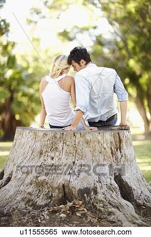 Couple sitting on tree stump View Large Photo Image Stock Photography - Couple sitting on tree stump. Fotosearch