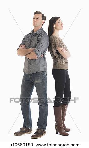 Stock Image - Couple standing back to back. Fotosearch
