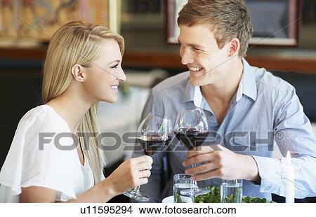 Picture - Couple toasting with wine. Fotosearch