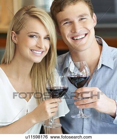 Couple toasting with wine View Large Photo Image Stock Photograph - Couple toasting with wine. Fotosearch