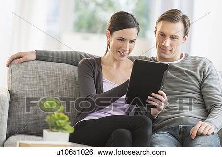 Couple using tablet pc View Large Photo Image Stock Photograph - Couple using tablet pc. Fotosearch