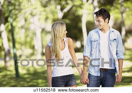 Couple walking in park View Large Photo Image Stock Photo - Couple walking in park. Fotosearch