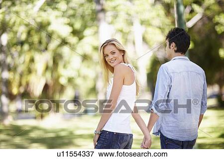 Stock Photo - Couple walking in park. Fotosearch