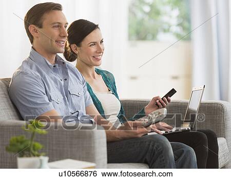 Couple watching tv together View Large Photo Image Stock Photograph - Couple watching tv together. Fotosearch