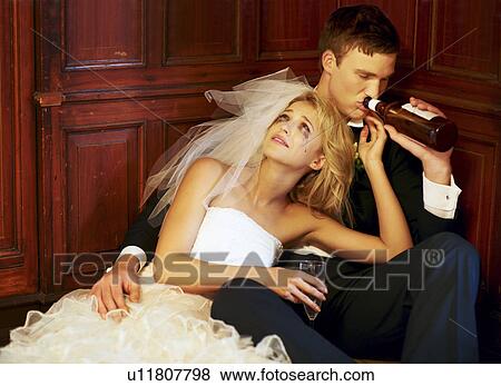 Drunk bride and groom sitting on floor View Large Photo Image Stock Photo - Drunk bride and groom sitting on floor. Fotosearch