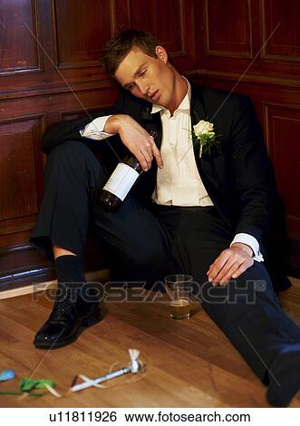 Stock Photograph - Drunk groom sitting on floor. Fotosearch