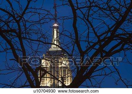 Stock Image - Empire State building illuminated at dusk. Fotosearch