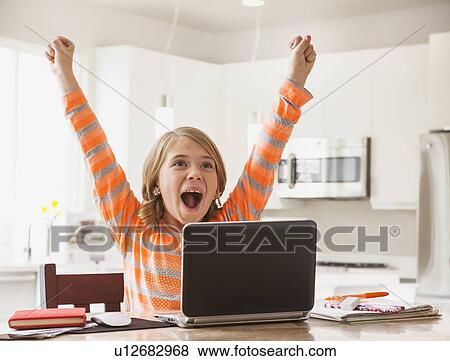 Excited girl (6-7) with laptop View Large Photo Image Stock Photo - Excited girl (6-7) with laptop. Fotosearch