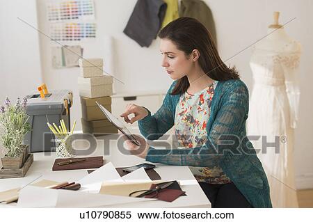 Fashion designer using digital tablet View Large Photo Image Stock Photography - Fashion designer using digital tablet. Fotosearch