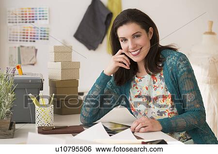 Stock Photograph - Fashion designer working in studio. Fotosearch