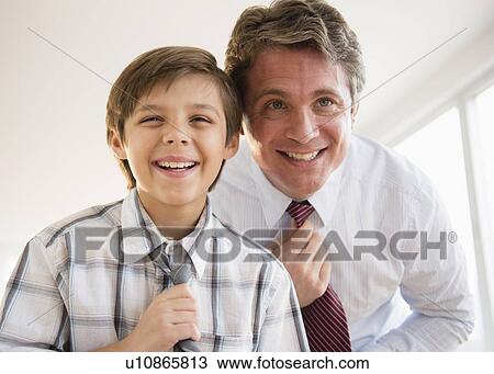 Father and son (8-9) adjusting ties View Large Photo Image Stock Image - Father and son (8-9) adjusting ties. Fotosearch