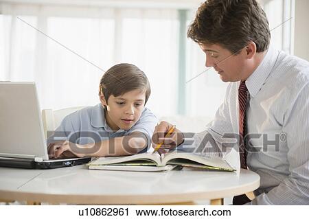 Father and son (8-9) doing homework View Large Photo Image Stock Image - Father and son (8-9) doing homework. Fotosearch