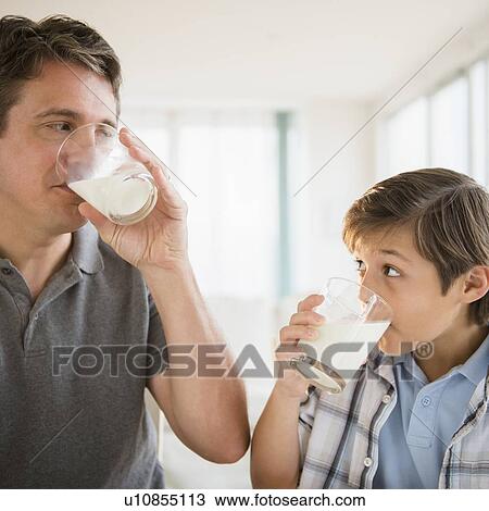 Father and son (8-9) drinking milk View Large Photo Image Stock Image - Father and son (8-9) drinking milk. Fotosearch