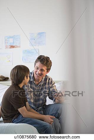 Father and son (8-9) talking View Large Photo Image Stock Image - Father and son (8-9) talking. Fotosearch