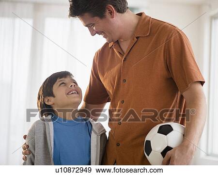 Father and son (8-9) with soccer ball View Large Photo Image Stock Photo - Father and son (8-9) with soccer ball. Fotosearch