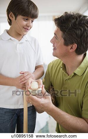 Father explain son (8-9) how to play baseball View Large Photo Image Stock Photo - Father explain son (8-9) how to play baseball. Fotosearch
