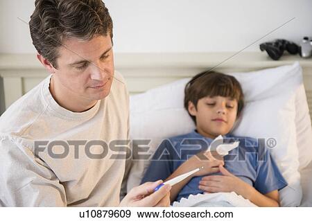 Father taking care of sick son (8-9) View Large Photo Image Stock Photo - Father taking care of sick son (8-9) . Fotosearch