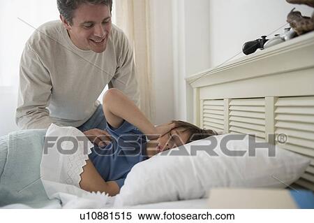 Stock Photography - Father waking up son (8-9) . Fotosearch